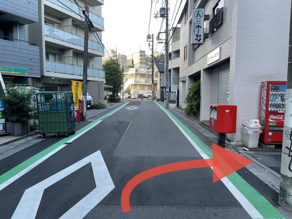 道なりの写真。右手に郵便ポストがあり、そこを右に曲がる指示の矢印画像が貼り付けてあります。
